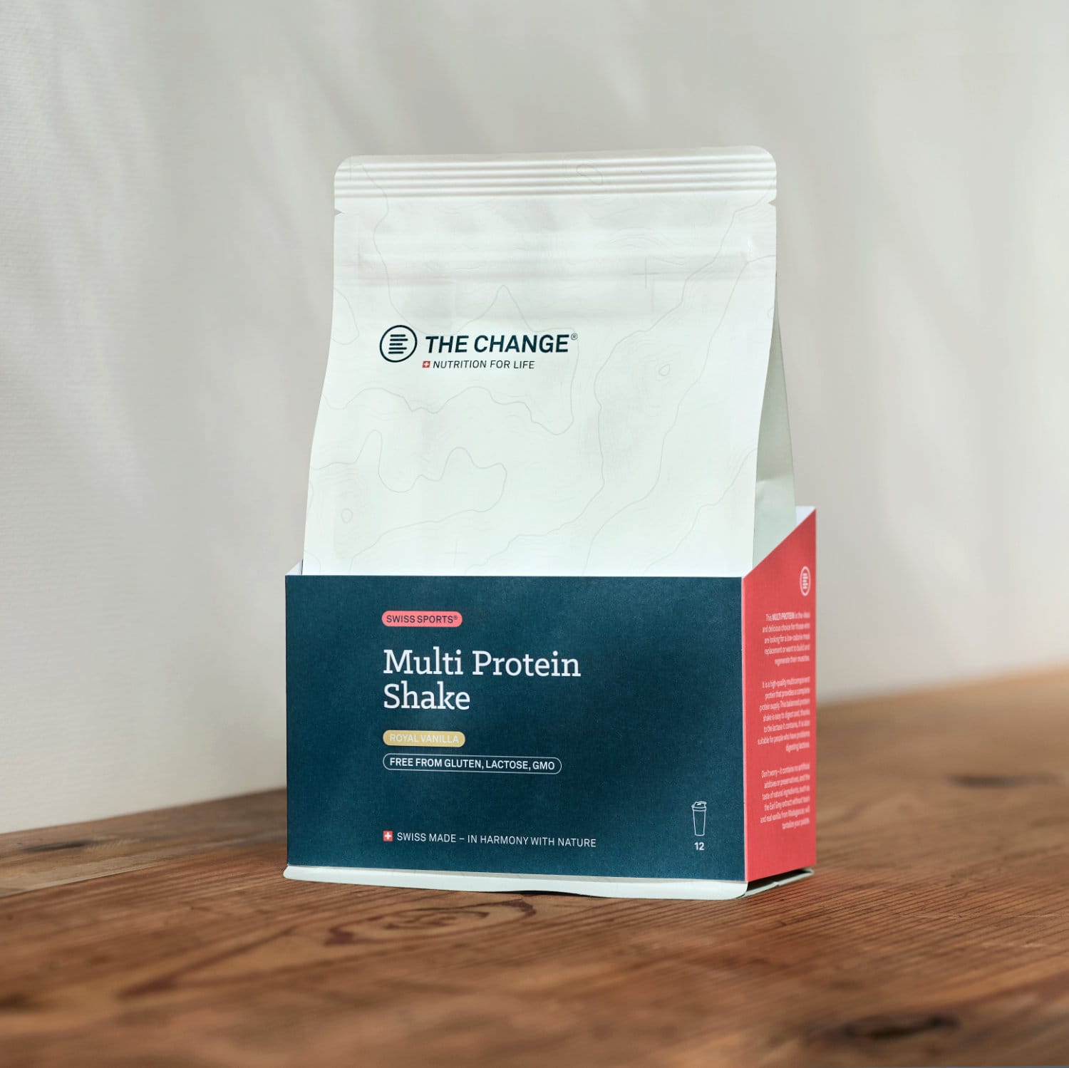 White and red packaging of The Change Multi Protein Shake, gluten and lactose-free nutrition product.
