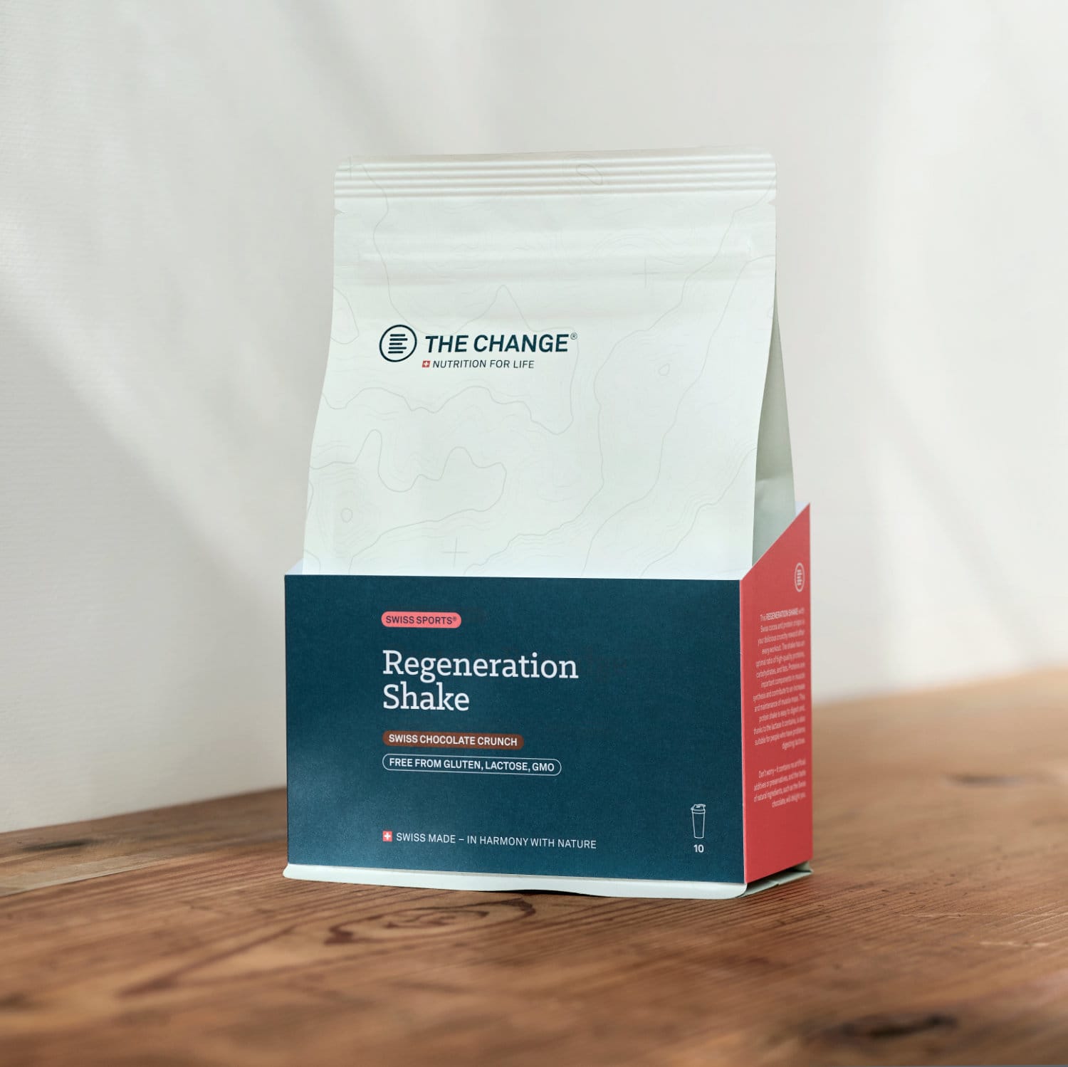 Swiss Chocolate Crunch Regeneration Shake in a blue and red eco-friendly packaging, gluten-free and GMO-free.