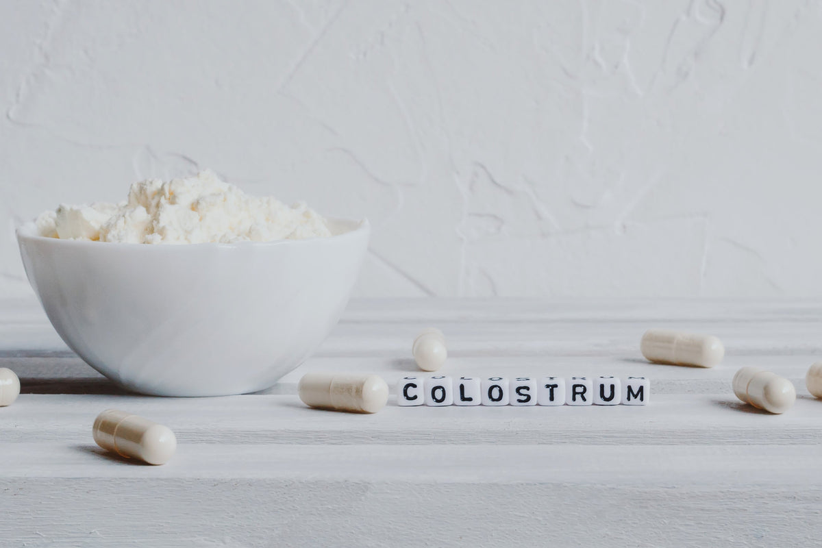 Pills capsules with colostrum, on a white background 