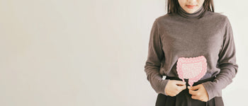 Woman with intestinal diagram over sweater