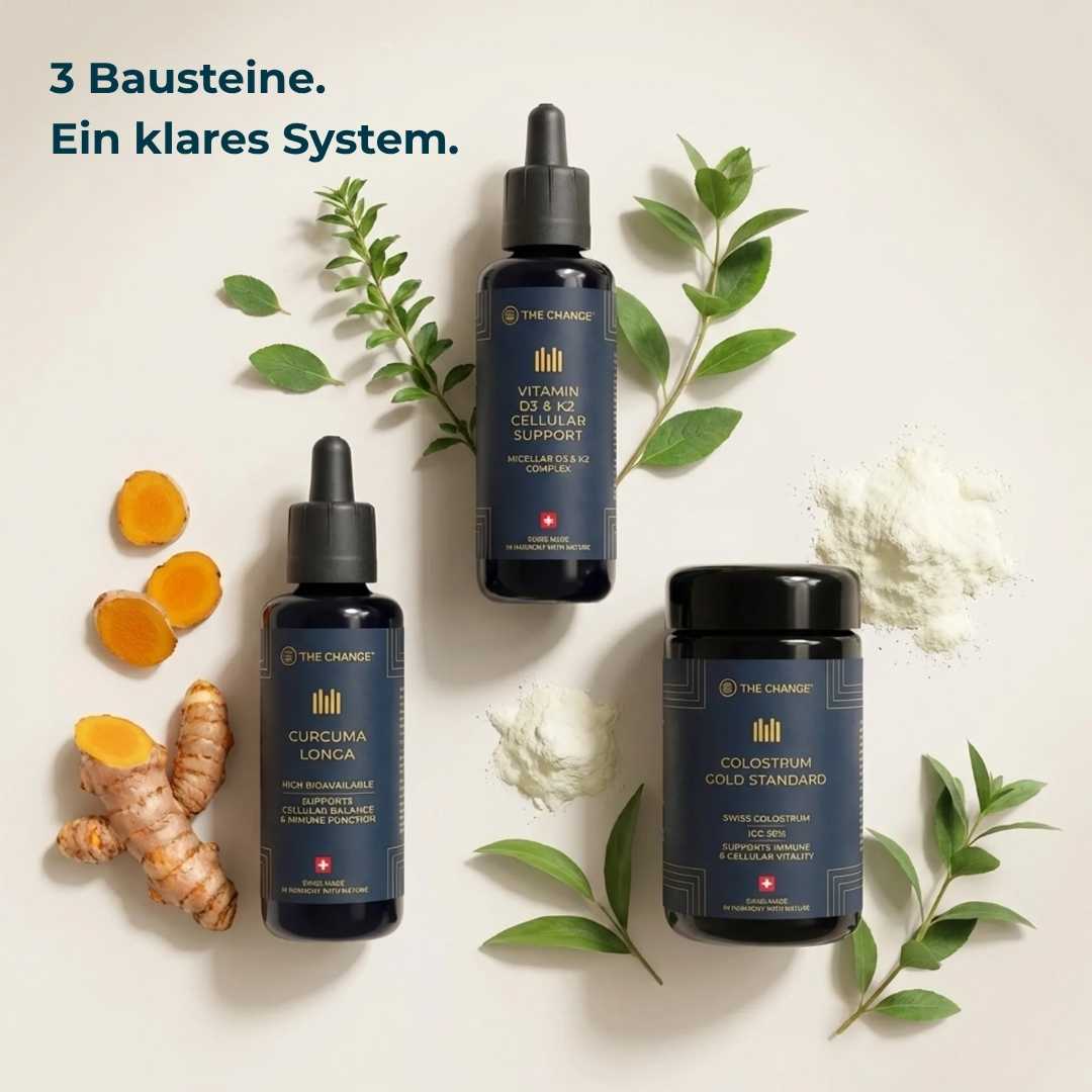 Three wellness supplements: dark glass bottles of Curcuma Longa, Vitamin D3, and Colostrum Cold Standard on a beige background.