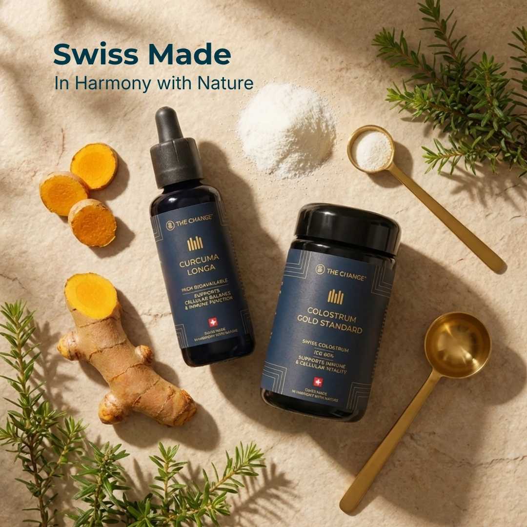 Curcuma Longa liquid supplement and Colostrum Gold Standard powder on a stone background, featuring turmeric roots and greenery.